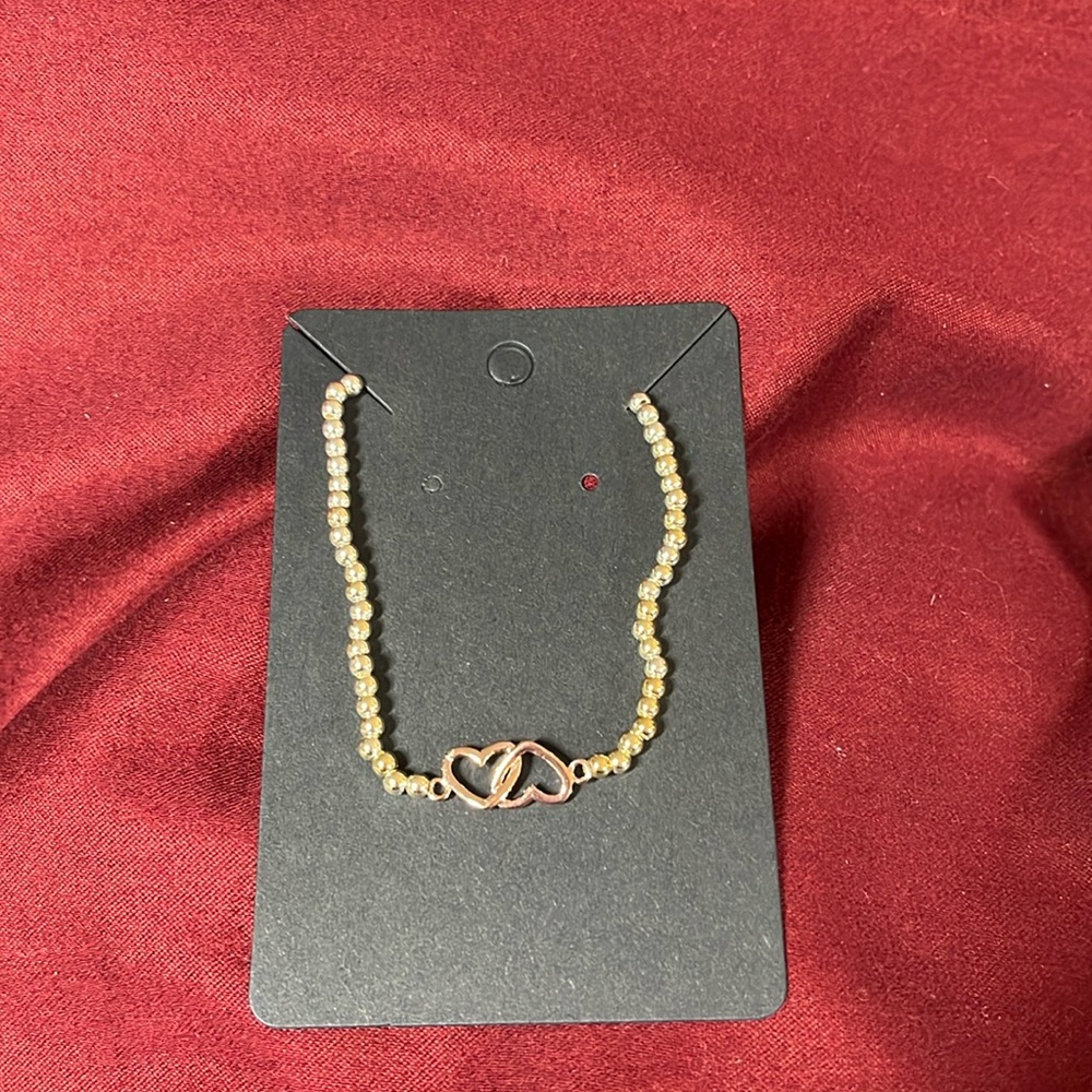 #141.  🔥Two Rose gold entwined hearts in a silver beaded elastic braclet